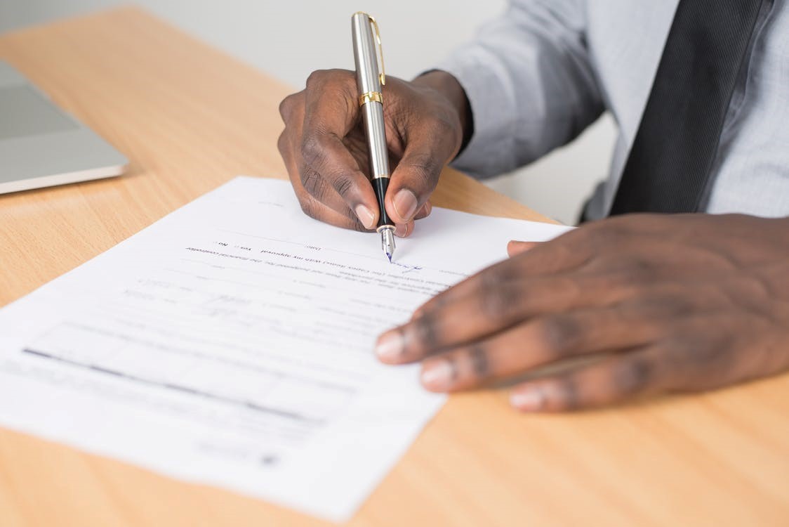 A man signing a bond contract